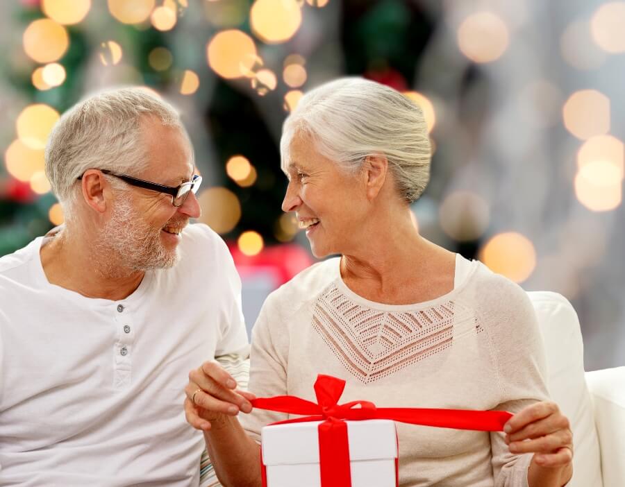 Older woman and man opening Christmas presents